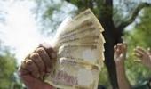 Rupee ends lower as dollar demand offsets shares recovery