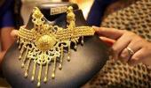 Gold falls on low demand; silver rises on global cues