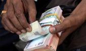 Rupee trims initial losses, trade almost flat vs USD