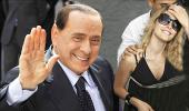 Scandal-hit Berlusconi to meet 'saintly' Dr Singh