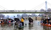 PICS: Houseboat owners stage floating protest in Srinagar