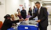 Obama flashes driving licence to cast historic vote