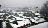 IN PICS: Heavy snowfall shuts down Kashmir