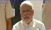 Modi in trouble with EC for flashing BJP symbol during presser