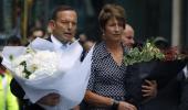 Australian PM Tony Abbott lays flowers at Sydney siege site