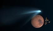 PHOTOS: Mountain-sized comet whizzes past Mars after a million years