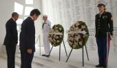 Wreaths and hugs: Japan's Abe offers sombre tribute at Pearl Harbor