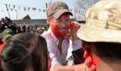 PHOTOS: Britain's Prince Harry sees red during Holi in Nepal