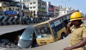 PHOTOS: Bus, car trapped in crater as Chennai road caves in