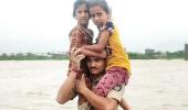 Guj cop carries 2 children on shoulders in floodwater