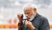 PM takes dip at Kumbh, washes feet of sanitation workers