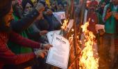 PIX: Farmers burn copies of agri laws on Lohri