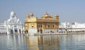 Woman with tiranga on cheek stopped at Golden Temple