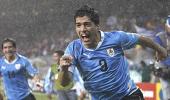 Suarez double puts Uruguay into last eight