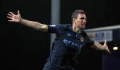 Deadly Edin Dzeko gives Man City precious victory