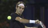 Federer cruises in Dubai as Murray labours