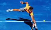 Federer rallies past Raonic, easy win for Nadal