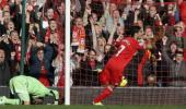 Suarez hat-trick keeps Liverpool on Arsenal's tail