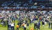 Villa charged following fans' pitch invasion