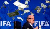 PHOTOS: Protester showers FIFA's Blatter with fake money