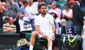 Laid low by sore knee, Wawrinka shown door by energetic Russian