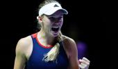 Wozniacki stays alive in Singapore; Federer survives scare