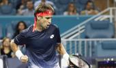 Federer fights back; Osaka stunned