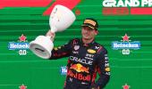 Record-equalling Verstappen bags rain-soaked win