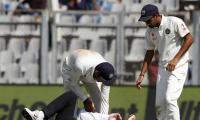 Umpire Reiffel leaves the field after being hit by ball