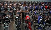 Motorcycles vroom past scooters on strong rural demand