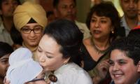 Sealed with a kiss: China's First Lady has all in smiles at Delhi school