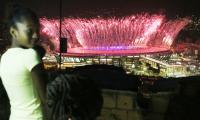 In favela above opening ceremony, pride and disappointment