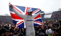 Hamilton collides but wins fourth title