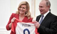 Croatian leader hands Putin soccer shirt before World Cup final