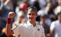 Federer earns milestone; Nadal powers past Goffin