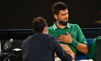 Injured Djokovic skips practice, awaits scans result