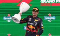 Record-equalling Verstappen bags rain-soaked win