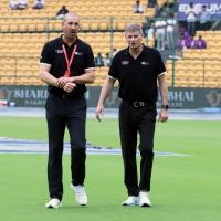 Umpires Michael Gough and Paul Reiffel inspect the outfield.