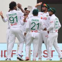 Bangladesh's players celebrate the wicket of India captain Rohit Sharma.