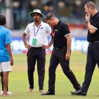 Umpires Richard Kettleborough and Chris Brown inspect the outfield.