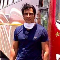 Sonu Sood with a bus he hired to send migrants home