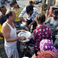 People buy milk in Kolkata amid the lockdown