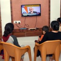 A family watches the PM's 8 pm address