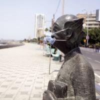 RK Laxman's Common Man wears a mask at Worli Seaface