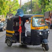 An auto driver in Mumbai uses a loudspeaker to create awareness