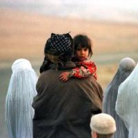 Afghan women flee the country in 1996. Pic: Reuters