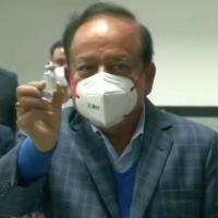 Health Minister Harsh Vardhan shows a dose of COVAXIN