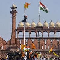 The 'Nishan Sahib' flag being hoisted on the Red Fort ramparts