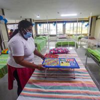A healthcare worker arranges a game of Ludo in a hospital