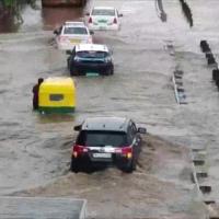 Cars float on a waterlogged road in Guruguram